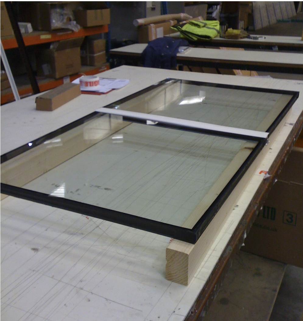 PVC Capped Munting bar is fully assembled between glazing panels