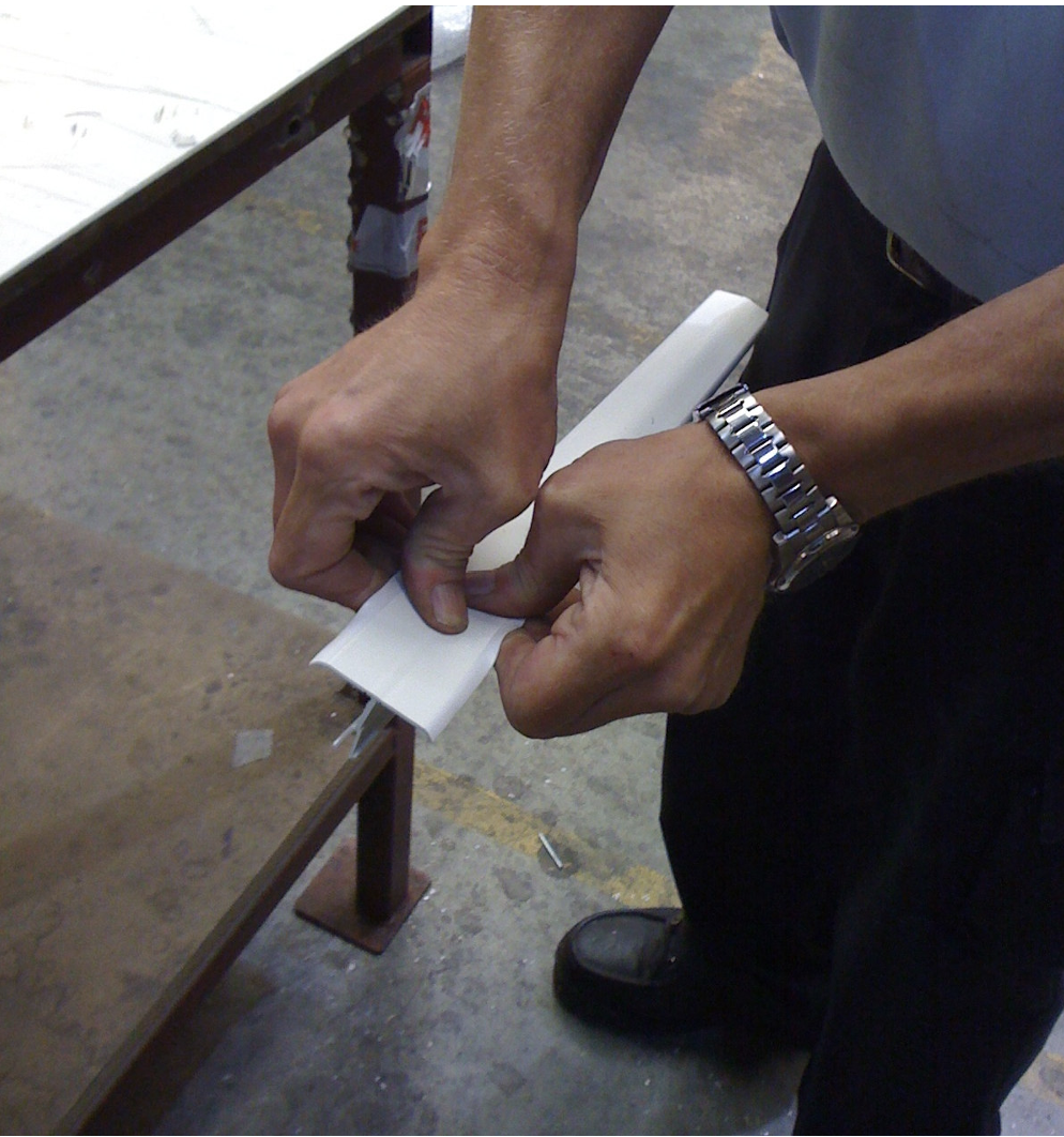 Sides of the PVC munting bar connector cap being bent in place