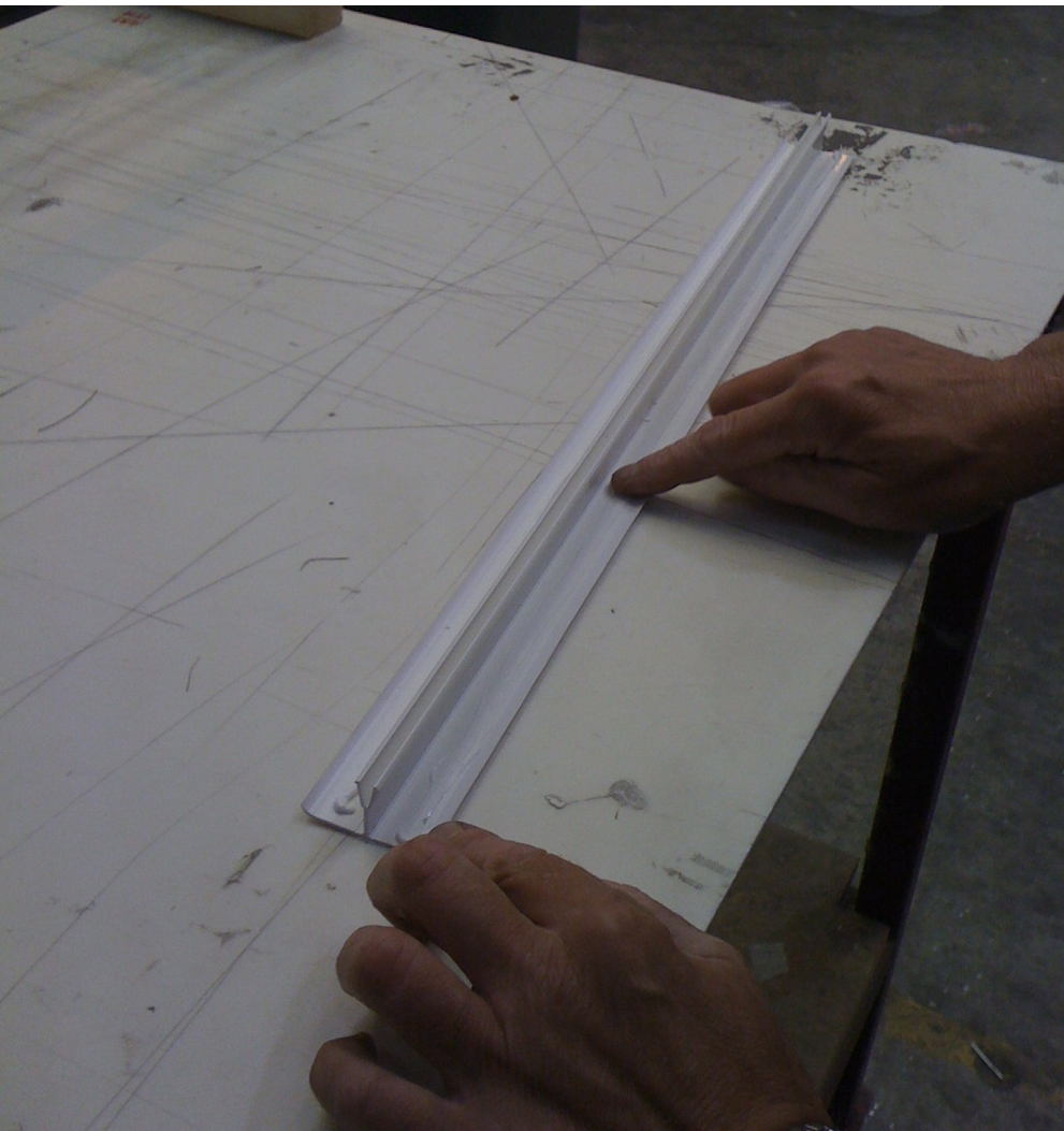 Excess silicone is being removed from the PVC munting bar connector cap